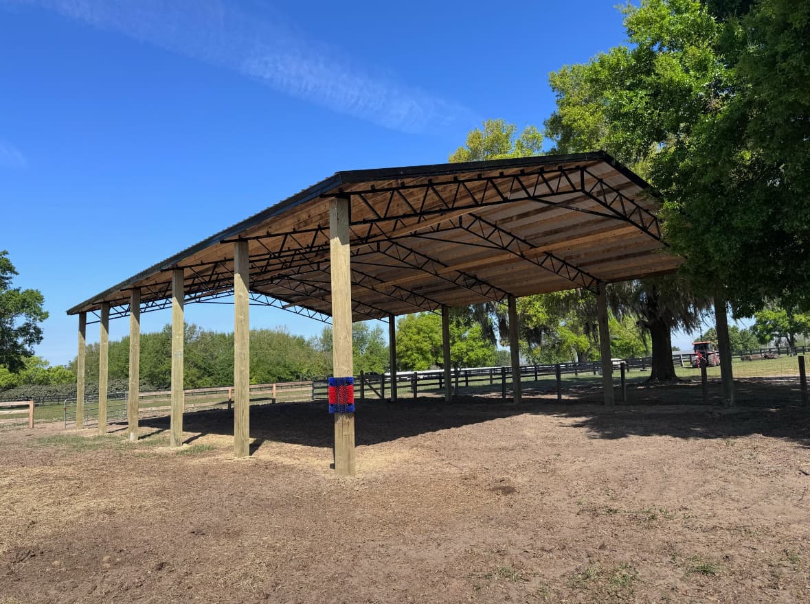 Open pole barn with gable and roof trim detail