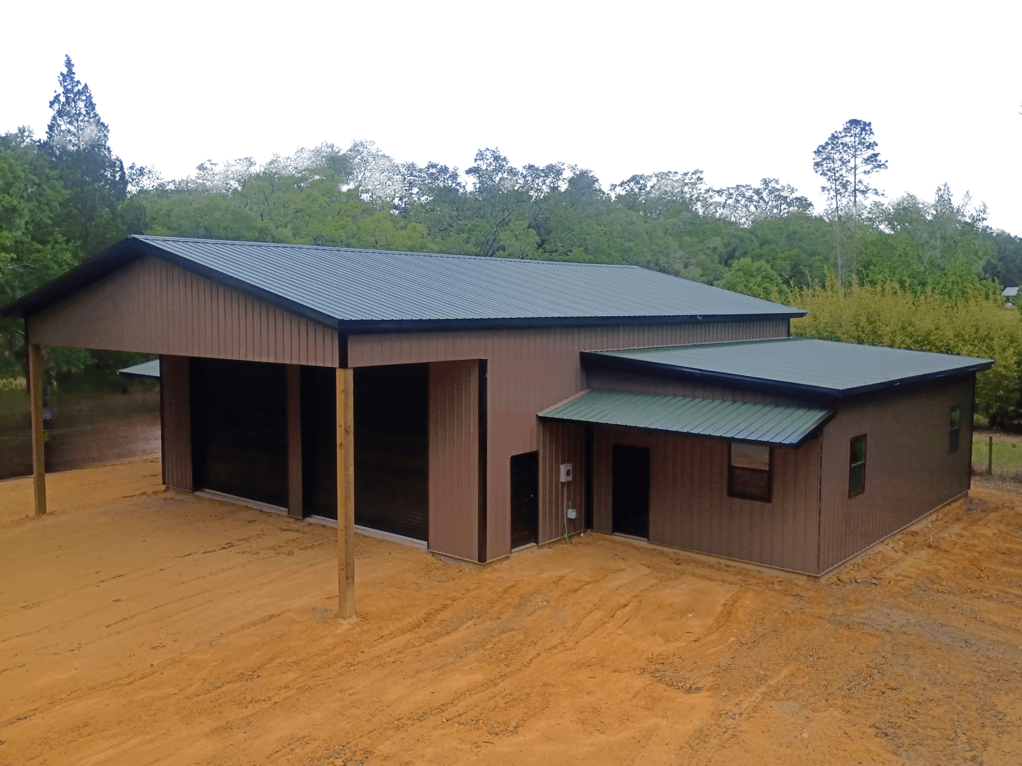 Enclosed pole barn kit with metal siding in Central Florida